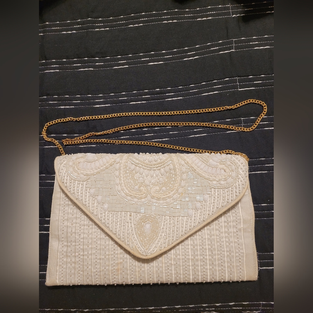 Shirdee white beaded purse with gold chain strap.